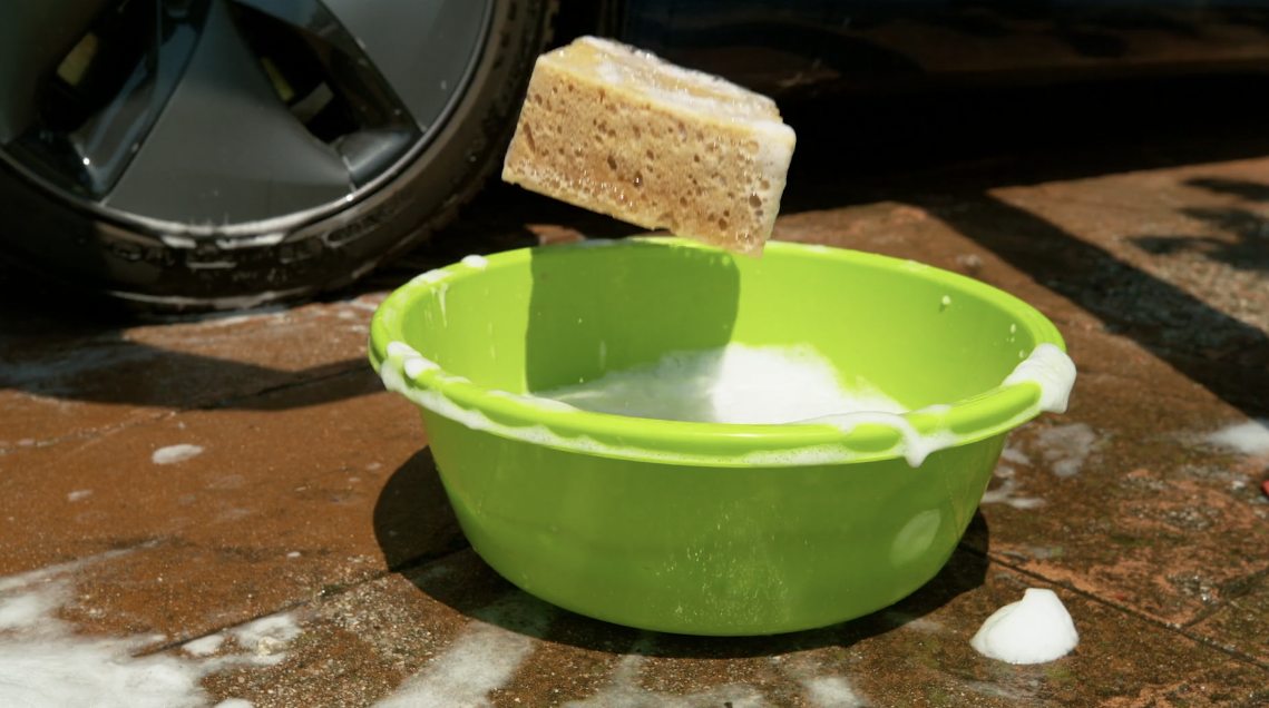 car-wrap-care-tips-with a bucket and sponge